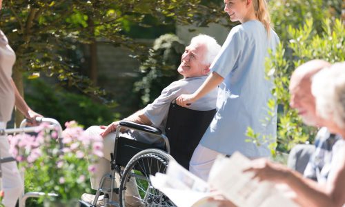 Staff walking with resident in wheelchair