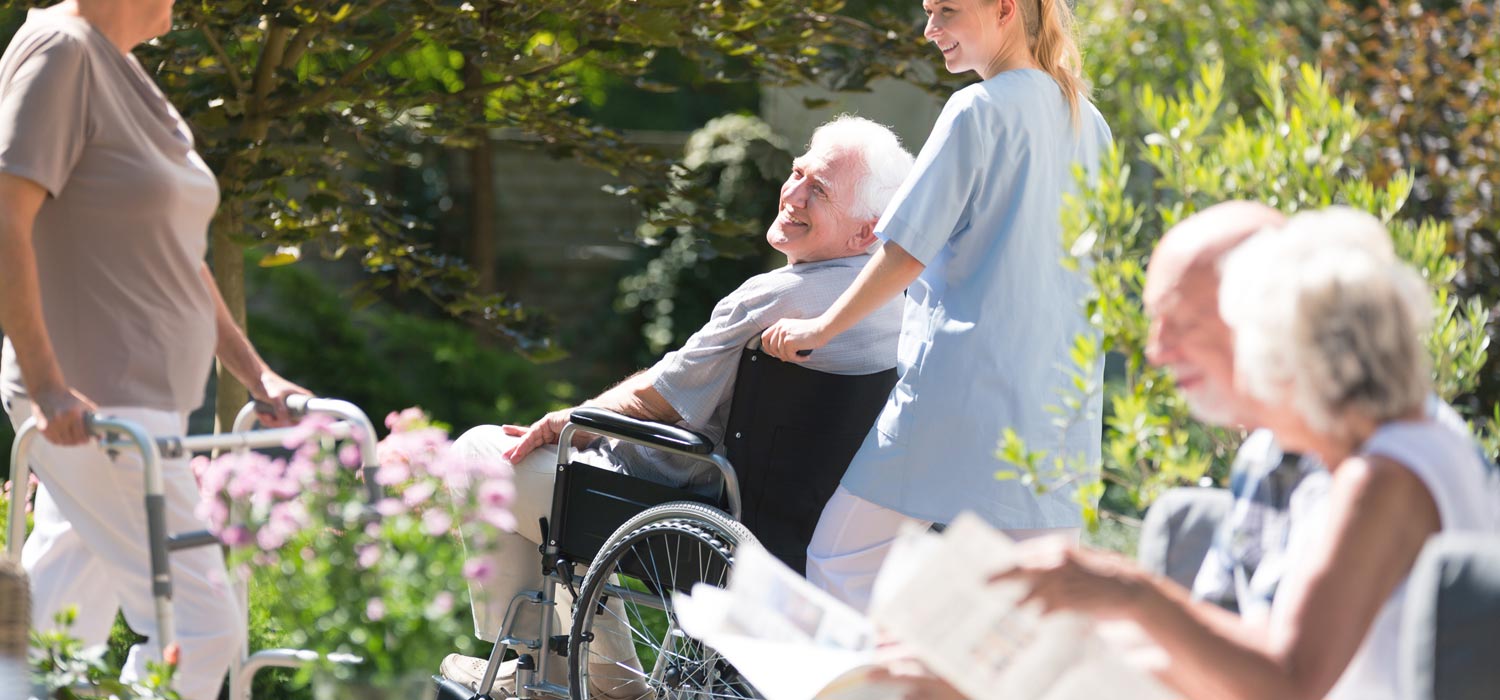 Staff walking with resident in wheelchair